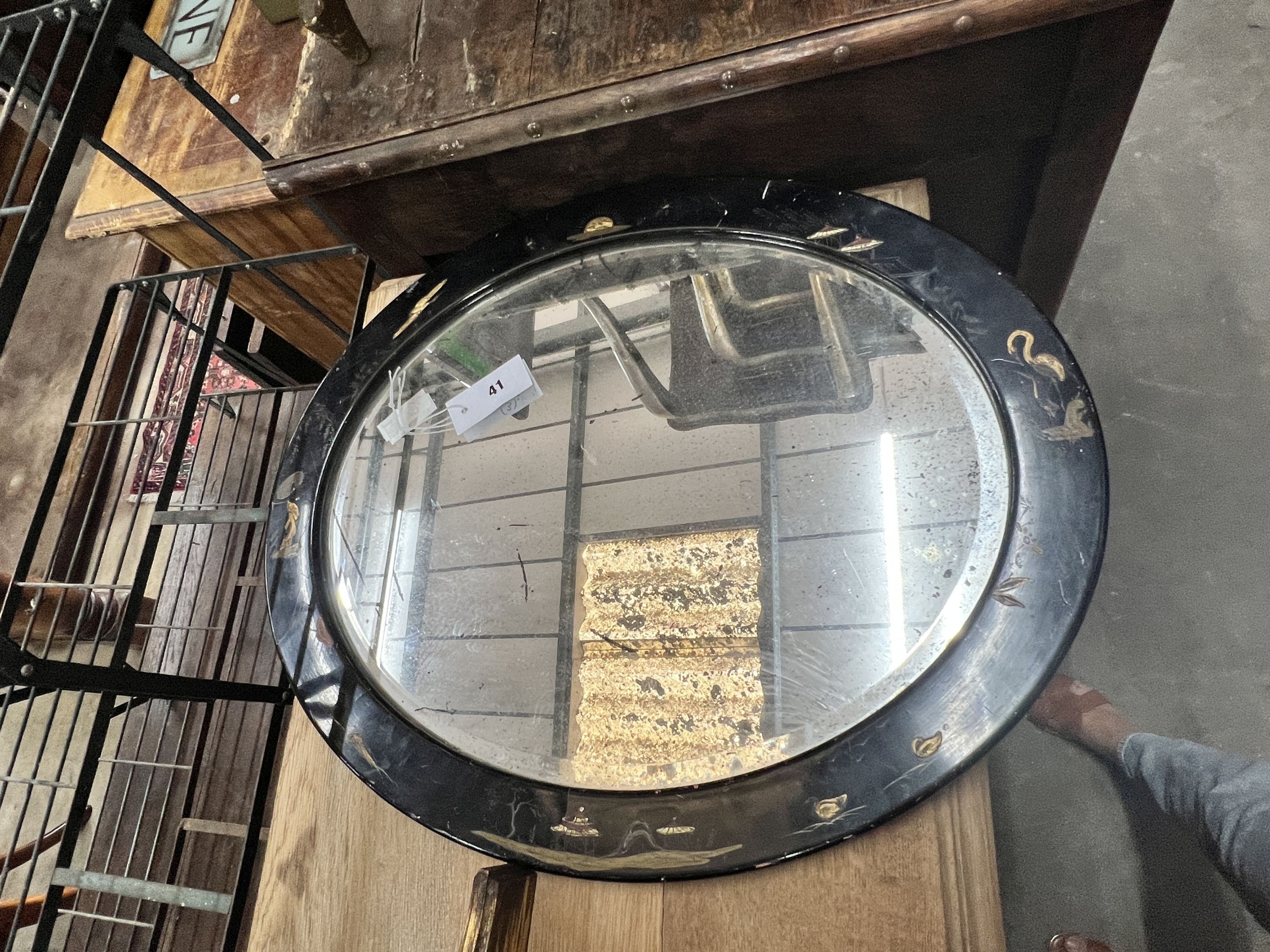 An oval gilt framed wall mirror, height 70cm, a matching wall bracket and an oval chinoiserie lacquered wall mirror, height 48cm